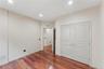 Hardwood-finish flooring throughout, featuring recessed lighting, white trim, and a double-door closet with clear knobs
