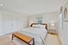 Bedroom featuring two closets, light wood-style floors, and recessed lighting