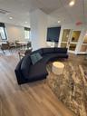 Living area with a drop ceiling, light wood-type flooring, and recessed lighting