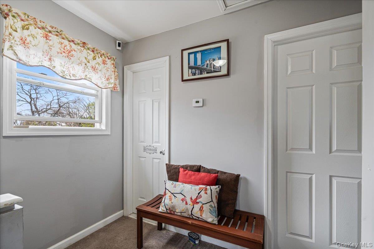 Window with white trim, light gray walls, and textured flooring