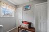 Window with white trim, light gray walls, and textured flooring