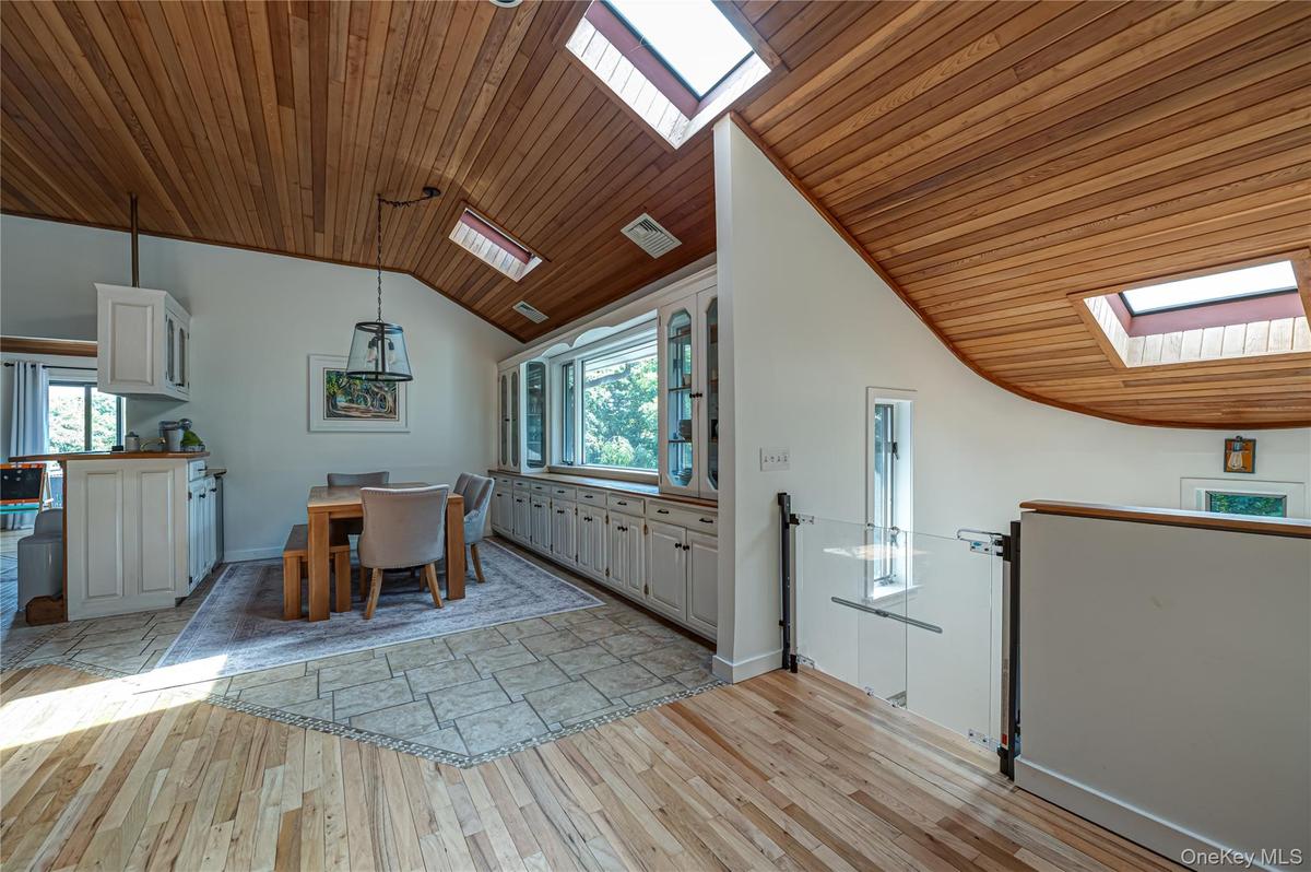 Dinning Room with Tile & Natural wood flooring, Built in's and Skylights