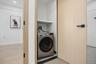 Washroom featuring washer / clothes dryer and light wood-style flooring