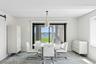 Dining area with a water view, a barn door, and wallpapered walls