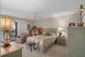 Primary bedroom features sliders to the patio & overlooks the beach
