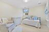 Carpeted bedroom featuring crown molding and recessed lighting.