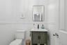Main floor half bath with marble tile