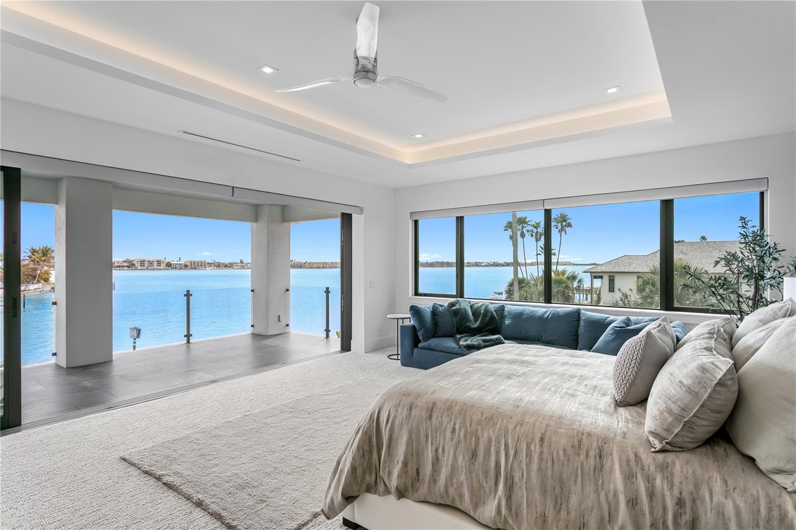 Primary suite's open water view with sliding door pocketed