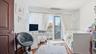 Bedroom with wood finished floors, crown molding, a wall unit AC, a desk, and access to outside