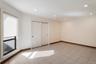 Room with light tile flooring, recessed lighting, and a window featuring a roller shade