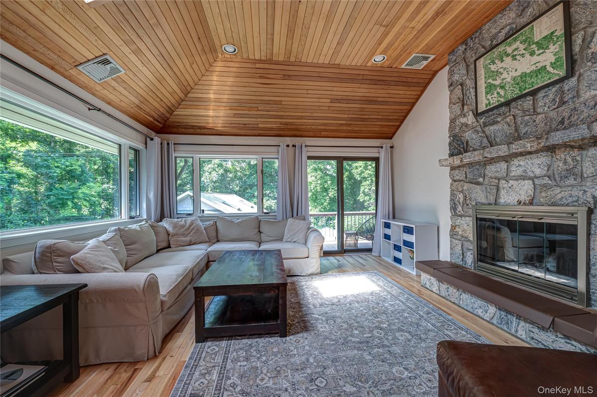 Living Room with Vaulted Ceilings, Natural Wood Floors and plenty of windows