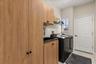 Laundry room with extra cabinets and a sink