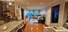 Corridor featuring crown molding, brick wall, light wood-style floors, a baseboard radiator, and recessed lighting