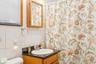 Full bath with backsplash, vanity, tile walls, and curtained shower