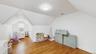 Playroom with light wood-type flooring, baseboards, vaulted ceiling, and visible vents