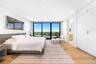 Bedroom featuring floor to ceiling windows, light wood-style floors, and recessed lighting