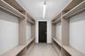 Virtually Staged walk-in closet area in lower  level.  Fabulous!