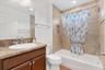 Front bedroom bath with tub/shower combo.