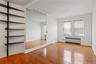 Unfurnished bedroom featuring light wood finished floors and radiator heating unit