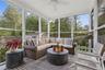 Sunroom with healthy amount of natural light, a ceiling fan, and outdoor lounge area
