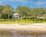 Beach home featuring a water view and a chimney