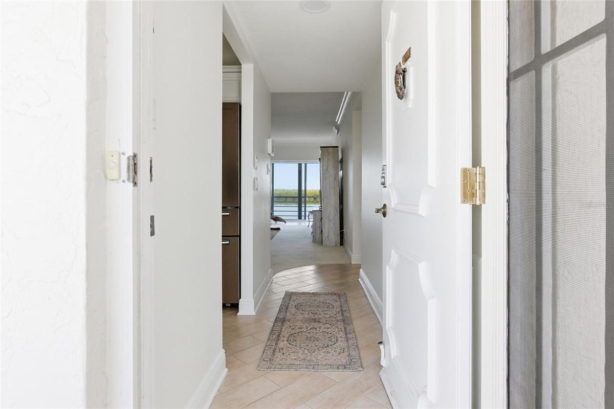 Walk into this light-filled condominium with unobstructed views of Sarasota Bay!