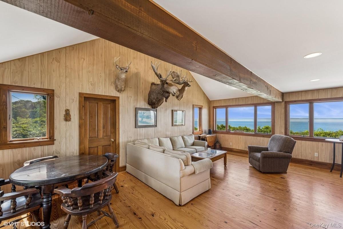 Living area featuring light wood-style flooring and wood walls