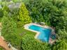L-Shaped tiled gunite saltwater gas heated pool, with attached in-ground circular spa