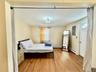 1- study with electric panel, baseboards, baseboard heating, and wood finished floors