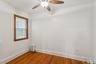 Spare room with radiator heating unit, dark wood finished floors, and ceiling fan