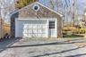 Detached garage featuring fence