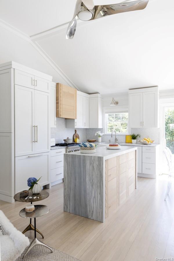 Open Gourmet Kitchen With Glass Sliders Leading To Backyard.