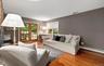 Living room with wood finished floors and a baseboard radiator