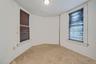 Unfurnished room with light colored carpet and baseboards