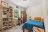 Interior room featuring carpeted flooring and crown molding