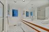 First floor bathroom featuring toilet, recessed lighting, visible vents, vanity, and a shower with door