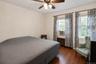 Wood-finish flooring, dual windows, and ceiling fan with integrated lighting