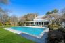 Pool featuring a lawn, grilling area, a pergola and a patio