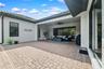Covered patio offers protection from the Florida sun when needed and includes a hurricane rolldown shutter.