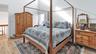 Bedroom featuring light wood-style floors and a high ceiling