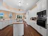 Windows throughout for natural lighting...lots of cabinet space for storage and a handy kitchen island