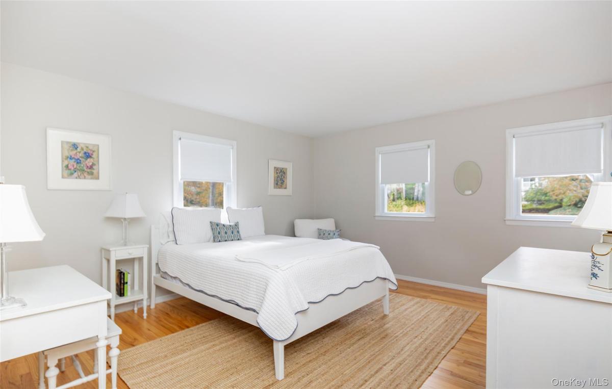Bedroom with light wood finished floors and baseboards