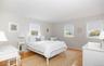 Bedroom with light wood finished floors and baseboards