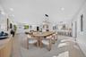 Open-concept living space featuring light wood-finish flooring, recessed lighting, and white walls