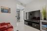Den with motorized leather couch seating and 75” smart TV