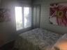 Bedroom featuring wood walls