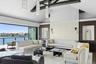 Carpeted living area with high vaulted ceiling, a water view, and recessed lighting