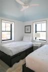 Bedroom featuring a ceiling fan and vaulted ceiling