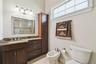Full bathroom with walk in shower and bidet connected to the media and game room.