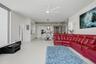“smart” family room features a comfortable leather sofa with three motorized loungers, a 120” state-of-the-art projection TV that rises from the floor